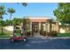 Community building with golf cart and landscaping at 1318 56Th W St # 1318, Bradenton, FL 34209