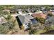 Aerial view of a home featuring a screened-in pool and patio area, surrounded by mature trees and landscaping at 14116 Nighthawk Ter, Lakewood Ranch, FL 34202