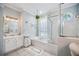 Bright bathroom featuring a soaking tub, glass-enclosed shower, and white vanity with marble countertop at 14116 Nighthawk Ter, Lakewood Ranch, FL 34202