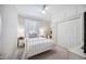 Cozy bedroom with white metal frame bed, white walls, carpeted floors, and a window at 14116 Nighthawk Ter, Lakewood Ranch, FL 34202