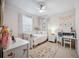 Light bedroom with white trim, desk, and a white daybed over carpet at 14116 Nighthawk Ter, Lakewood Ranch, FL 34202