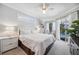 Bright, stylish bedroom boasts a sliding glass door to the pool area and modern furnishings at 14116 Nighthawk Ter, Lakewood Ranch, FL 34202