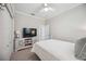 Bedroom with carpet floors, tv on display, white walls, white trim, and window at 14116 Nighthawk Ter, Lakewood Ranch, FL 34202