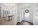 Bright foyer features wood floors, a chandelier, and a dining area to the left at 14116 Nighthawk Ter, Lakewood Ranch, FL 34202