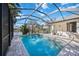 Pool with screened enclosure, lakeside views, and outdoor dining area at 14116 Nighthawk Ter, Lakewood Ranch, FL 34202