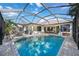 Screened-in pool area with brick flooring, lake views, and outdoor dining area at 14116 Nighthawk Ter, Lakewood Ranch, FL 34202