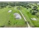 Aerial view of property showing house, pond, and pastures at 15409 Waterline Rd, Bradenton, FL 34212