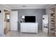 Bedroom with white dresser, large TV, and gray accent wall at 15409 Waterline Rd, Bradenton, FL 34212