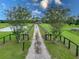 Long driveway leading to a beautiful home with lush landscaping at 15409 Waterline Rd, Bradenton, FL 34212