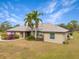 Single story house with landscaping and palm trees in front at 15409 Waterline Rd, Bradenton, FL 34212