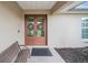 Double front doors with wreaths, a bench and a tiled entryway at 15409 Waterline Rd, Bradenton, FL 34212