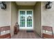 Double front doors with wreaths and a small seating area at 15409 Waterline Rd, Bradenton, FL 34212