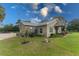 Side view of a single-story house with landscaping and a grassy yard at 15409 Waterline Rd, Bradenton, FL 34212