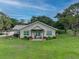 Front view of a ranch-style house with a porch and well-maintained lawn at 15409 Waterline Rd, Bradenton, FL 34212