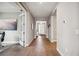 Long hallway with light hardwood floors and access to other rooms at 16008 Crofton Springs Way, Port Charlotte, FL 33953