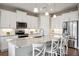 Modern kitchen with white cabinets and granite island at 16008 Crofton Springs Way, Port Charlotte, FL 33953