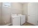 Laundry room with washer, dryer, and shelving at 16008 Crofton Springs Way, Port Charlotte, FL 33953