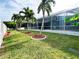 Backyard view of home with tropical landscaping at 18652 Ohara Dr, Port Charlotte, FL 33948