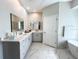 Bathroom with dual vanity, grey cabinets, and marble-look tile floor at 18652 Ohara Dr, Port Charlotte, FL 33948