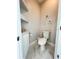 Small powder room with toilet and floating shelves at 18652 Ohara Dr, Port Charlotte, FL 33948