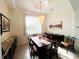 Formal dining room with a large table and chandelier at 18652 Ohara Dr, Port Charlotte, FL 33948