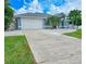 Home's exterior showcasing a large driveway and garage at 18652 Ohara Dr, Port Charlotte, FL 33948