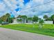 House's exterior with a spacious lawn and driveway at 18652 Ohara Dr, Port Charlotte, FL 33948