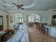 Open living room with white couches, adjacent dining area and kitchen at 18652 Ohara Dr, Port Charlotte, FL 33948