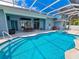 Large screened-in pool and spa with spacious patio and seating at 18652 Ohara Dr, Port Charlotte, FL 33948