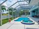 Relaxing screened-in pool and spa area with outdoor dining at 18652 Ohara Dr, Port Charlotte, FL 33948