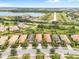 Aerial view of houses and a lake in a community at 19066 Mangieri St, Venice, FL 34293