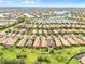 Aerial view of houses and a lake in a community at 19066 Mangieri St, Venice, FL 34293