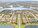 Aerial view of community with pool, tennis courts, and lake at 19066 Mangieri St, Venice, FL 34293