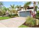 House exterior showcasing landscaping, driveway and a gray garage door at 19066 Mangieri St, Venice, FL 34293