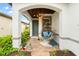 Relaxing front porch with hanging chair and a charming wooden ceiling at 19066 Mangieri St, Venice, FL 34293