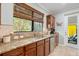 Kitchen features granite countertops and a door to backyard at 19066 Mangieri St, Venice, FL 34293