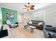 Living room with gray sofa, accent chair, and a large-format artwork at 19066 Mangieri St, Venice, FL 34293