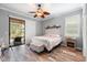 Main bedroom with king bed, ceiling fan, and access to back patio at 19066 Mangieri St, Venice, FL 34293