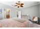 Main bedroom with king bed, ceiling fan, and en-suite bathroom at 19066 Mangieri St, Venice, FL 34293