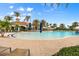 Relaxing pool area with lounge chairs, umbrellas, and a view of the clubhouse at 19066 Mangieri St, Venice, FL 34293