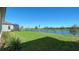 Grass lawn backyard with pond view at 209 Brindisi Cir, Nokomis, FL 34275