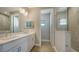 Double vanity bathroom with a walk-in shower at 209 Brindisi Cir, Nokomis, FL 34275