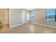 Spacious bedroom with wood-look floors and lake view at 209 Brindisi Cir, Nokomis, FL 34275