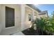 Dark brown front door entry to a home with a covered porch at 209 Brindisi Cir, Nokomis, FL 34275