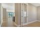 Hallway view with a glass door and view into a living area at 209 Brindisi Cir, Nokomis, FL 34275