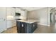 Modern kitchen with white cabinets and dark island at 209 Brindisi Cir, Nokomis, FL 34275