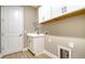 Convenient laundry room with white cabinets and sink at 209 Brindisi Cir, Nokomis, FL 34275