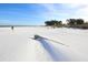 Person walking on a pristine beach at 210 Willow Ave, Anna Maria, FL 34216