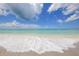 Waves rolling onto a sandy beach at 210 Willow Ave, Anna Maria, FL 34216