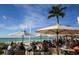 Outdoor seating at beachfront restaurant with umbrellas and ocean views at 210 Willow Ave, Anna Maria, FL 34216